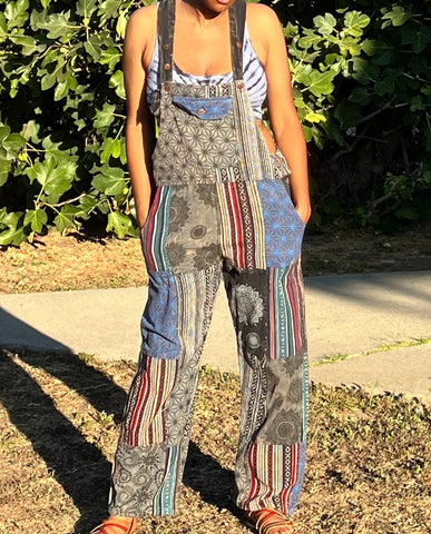 Model wearing handmade patchwork cotton overalls with wide legs and multi-color fabric panels, outdoors in natural light.