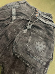 Close-up of zippered side pocket on black acid wash pants