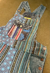 Flat lay front view close-up of pocket and patchwork details on blue patchwork overalls