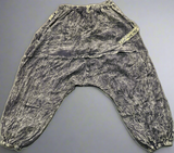 Flat lay back view of olive green pants showing drape panel