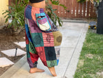 Side view of colorful patchwork harem pants showing cargo pocket