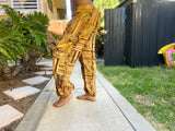 Side view of sunflower patchwork pants with golden tones