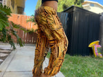 Model walking in sunflower patchwork pants side view outdoors