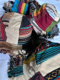 Group of handmade boho bucket hats with colorful patchwork fabric and frayed edges displayed together