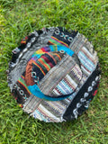 Top view of dark toned patchwork bucket hat with frayed brim