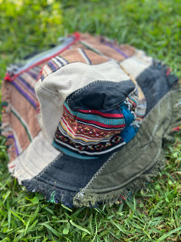 Angled view of light multicolor patchwork bucket hat with frayed brim